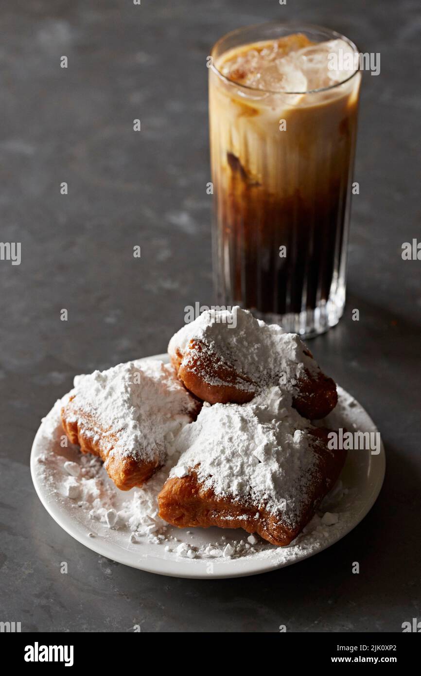 Beignets - pasticceria fritta con zucchero a velo, caffè ghiacciato Foto Stock