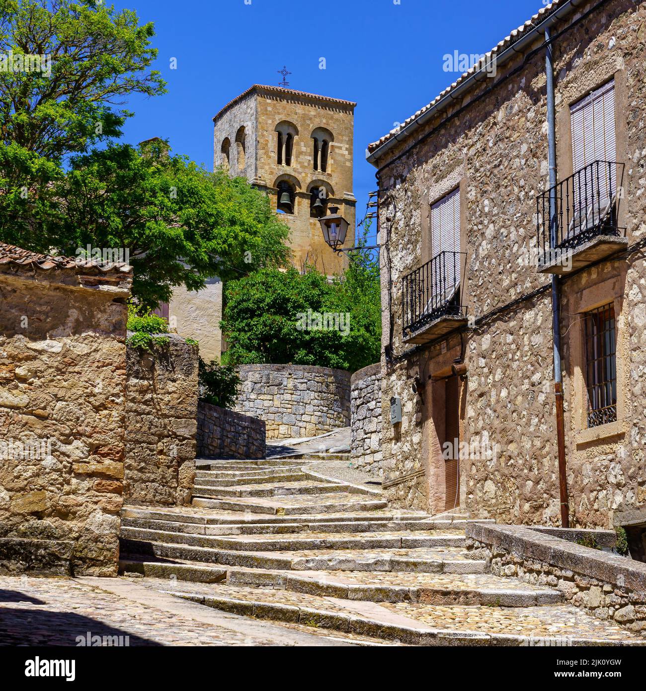 Antica chiesa romanica con il suo accesso di vecchie scale di pietra e il suo campanile. Sepulveda. Segovia. Foto Stock