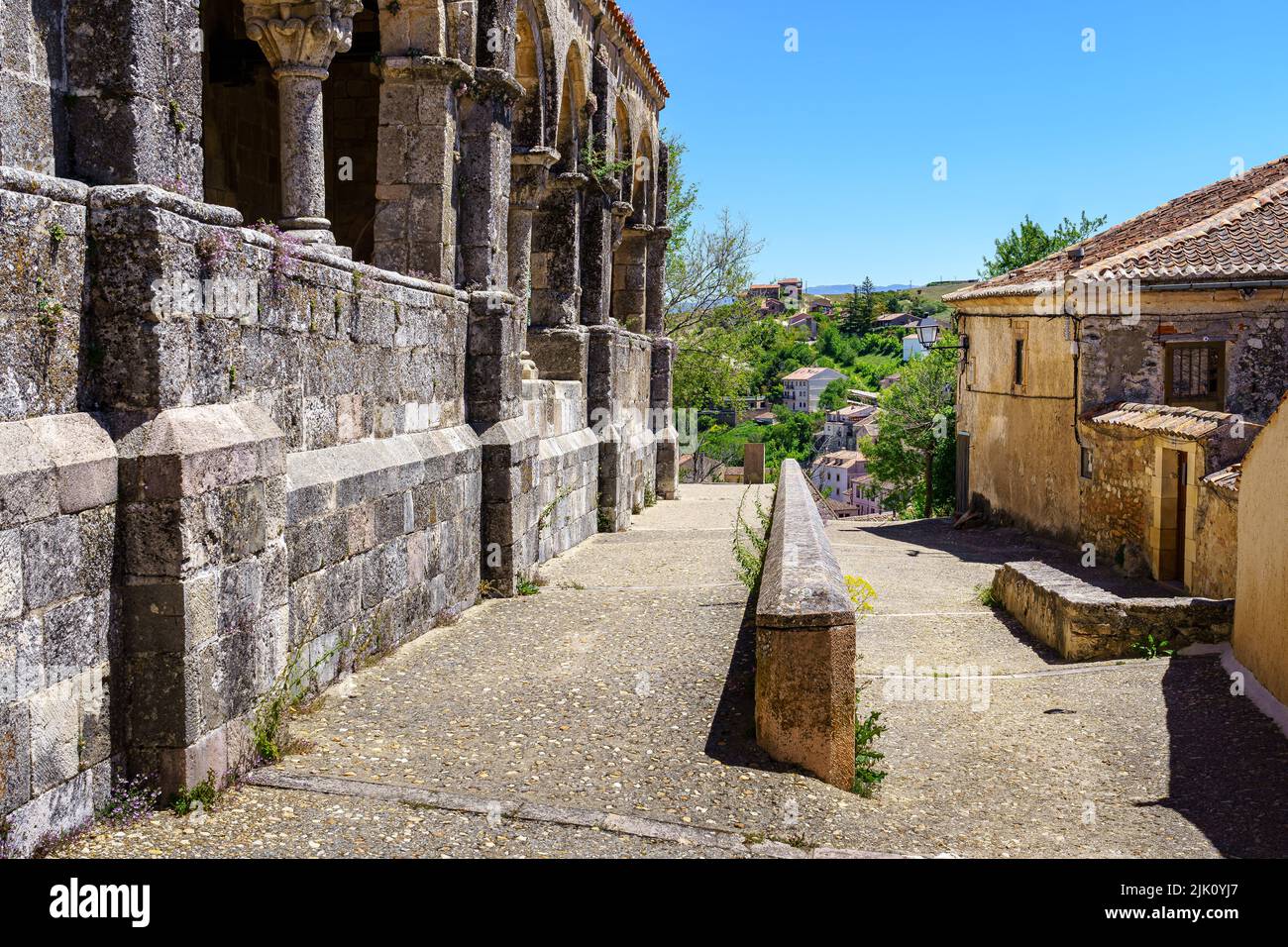 Vecchia chiesa antica accanto a case in pietra e strada di accesso stretto al recinto. Sepulveda. Foto Stock