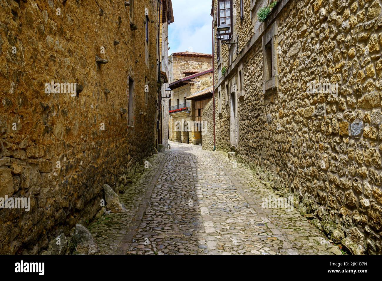 Vicolo stretto con vecchie case in pietra e archi di edifici medievali. Santillana del Mar, Santander. Foto Stock