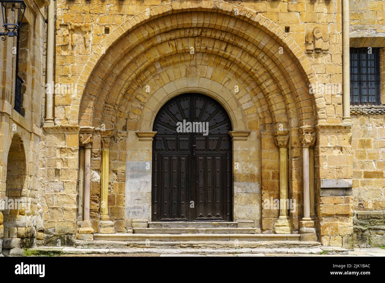 Porta principale ad arco, ingresso ad una vecchia chiesa romanica nel nord della Spagna. Santillana del Mar, Cantabria. Foto Stock