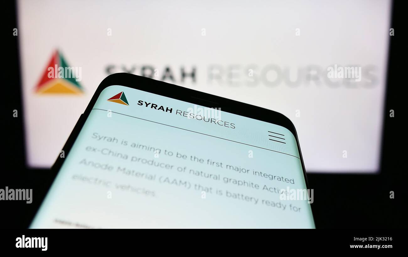 Smartphone con pagina web della società australiana Syrah Resources Limited sullo schermo di fronte al logo aziendale. Mettere a fuoco sulla parte superiore sinistra del display del telefono. Foto Stock