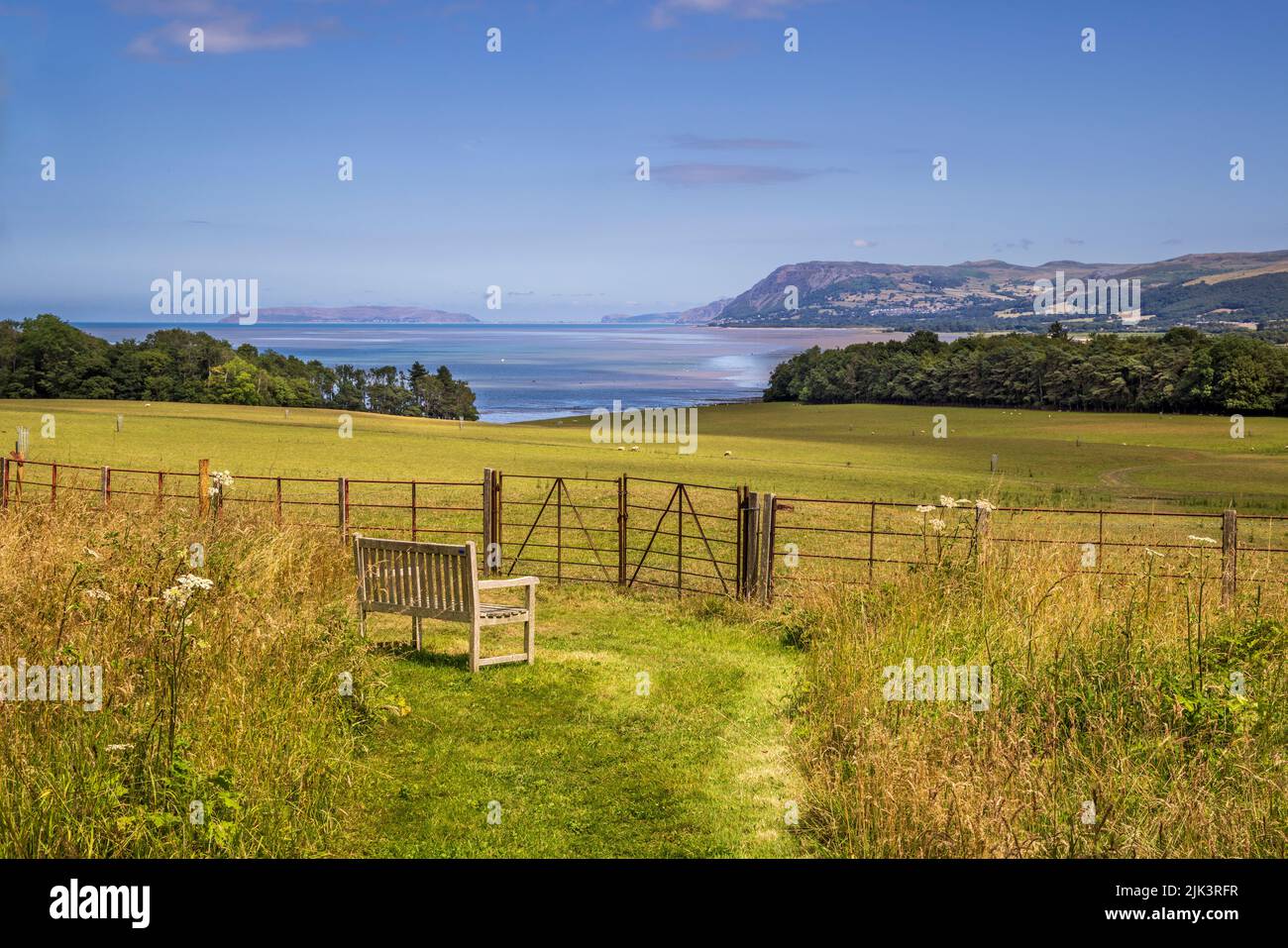 La vista della costa verso il Grande Orme dai terreni del castello di Penrhyn, Gwynedd, Galles del Nord Foto Stock