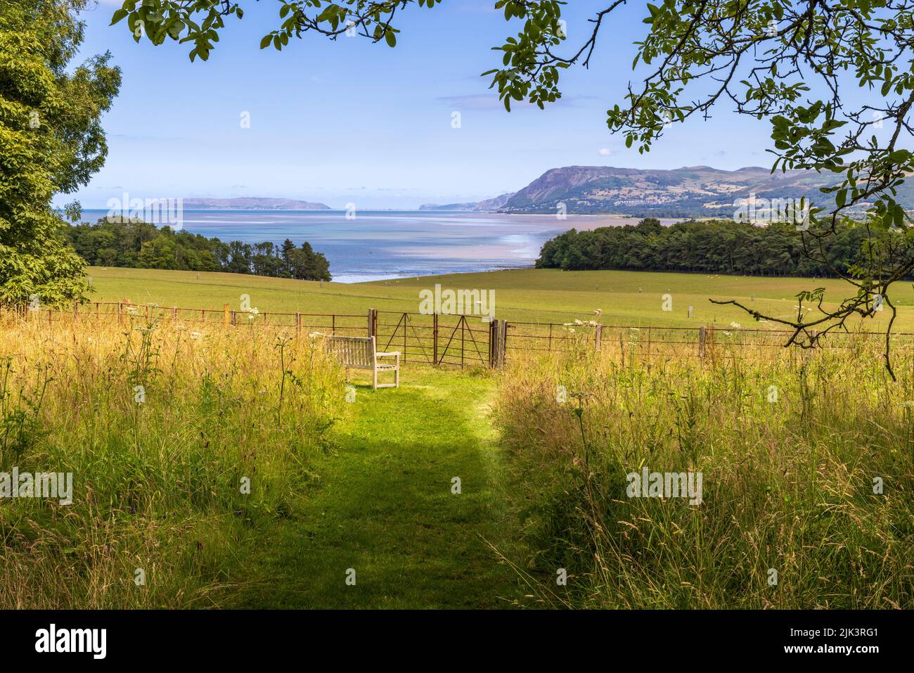 La vista della costa verso il Grande Orme dai terreni del castello di Penrhyn, Gwynedd, Galles del Nord Foto Stock