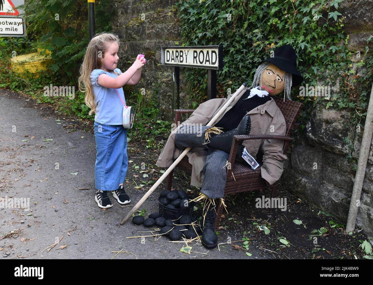 Bambino piccolo fotografando uno spaventapasseri al festival di Scarecrow di Coalbrookdale Foto Stock