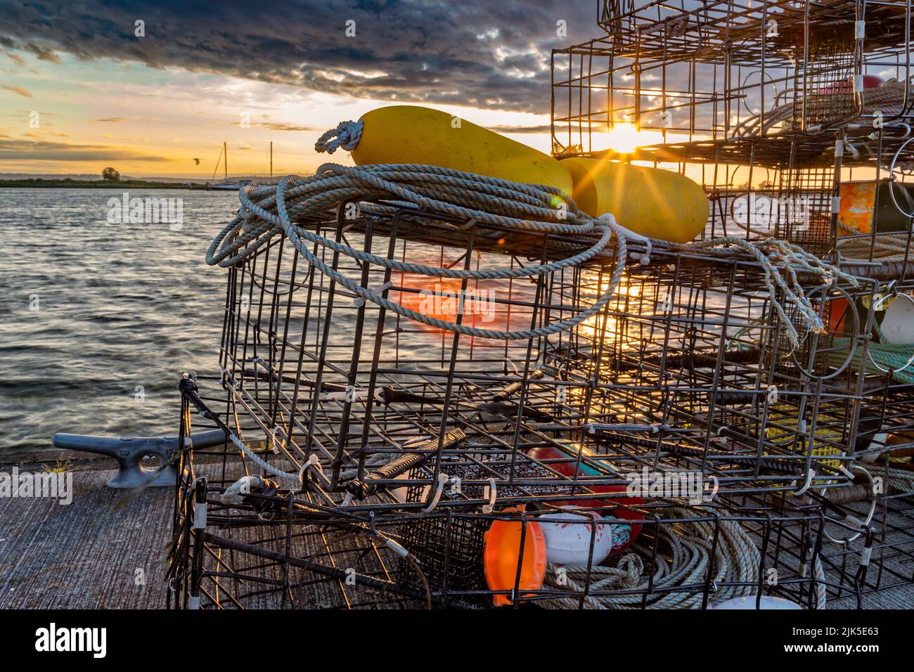 Gabbie di granchio sul molo di Everett Marina. Sullo sfondo, tramonti su Jetty Island Foto Stock