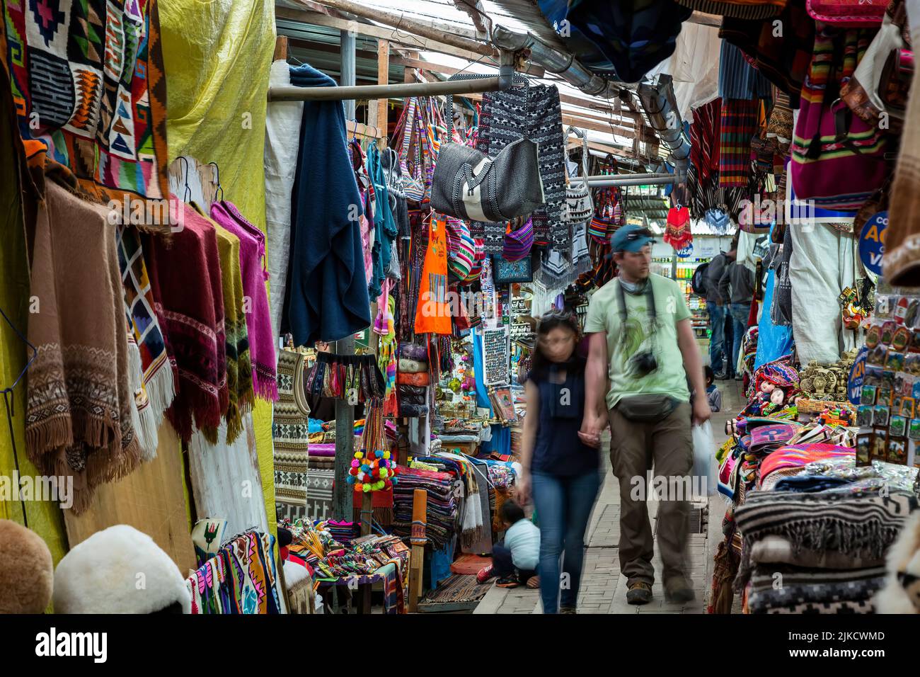 Coppia camminando attraverso il mercato Artisans, Aguas Calientes, aka Machu Picchu Pueblo, Urubamba, Cusco, Perù Foto Stock