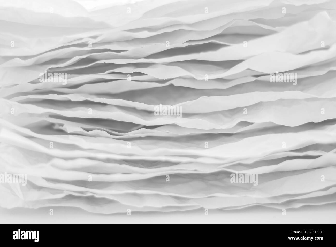 i livelli di carta grigi impilano uno sfondo astratto ondulato Foto Stock
