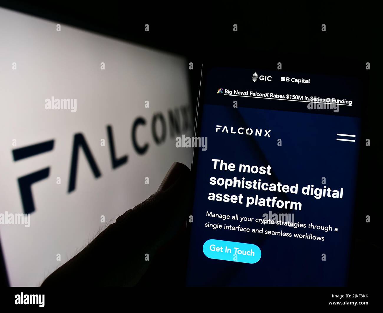 Persona che detiene il cellulare con il sito web della società di criptazione statunitense FalconX Limited sullo schermo di fronte al logo. Concentrarsi sul centro del display del telefono. Foto Stock