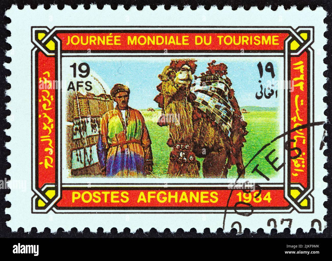 AFGHANISTAN - CIRCA 1984: Un francobollo stampato in Afghanistan dal numero 'World Tourism Day' mostra cammello driver e cammello, circa 1984. Foto Stock