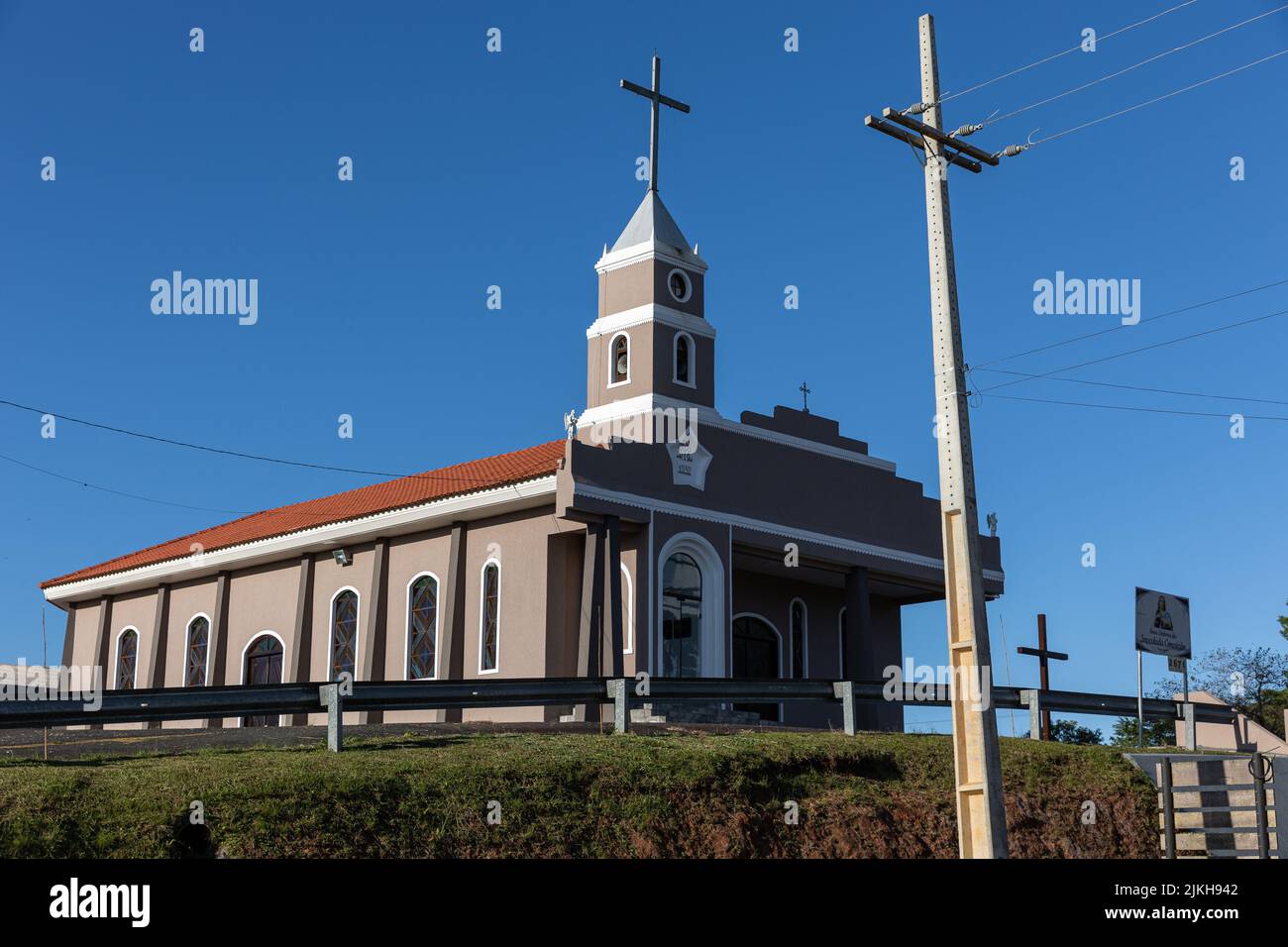 Una vista panoramica di una chiesa cattolica contro un cielo blu senza nuvole Foto Stock