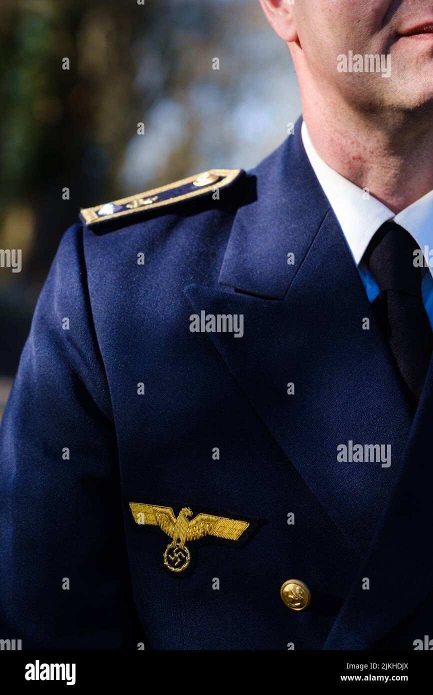 Un primo piano verticale di un uomo che indossa un'uniforme militare tedesca blu del generale Wehrmacht Foto Stock