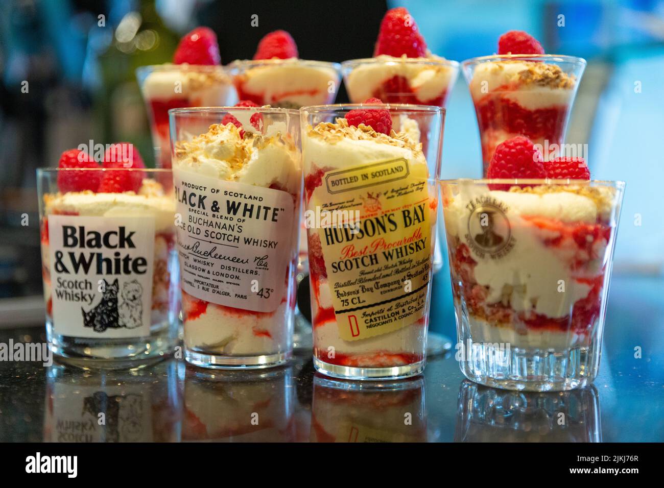 Shot di whiskey in bicchieri con shortbread scozzese e dessert alla crema di fragole Foto Stock