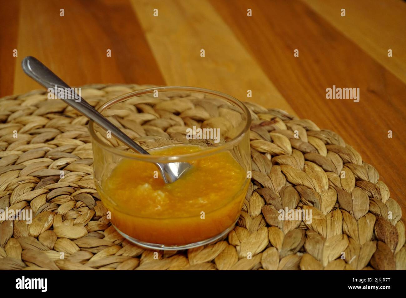 Marmellata d'arancia in bicchiere con cucchiaio d'argento Foto Stock