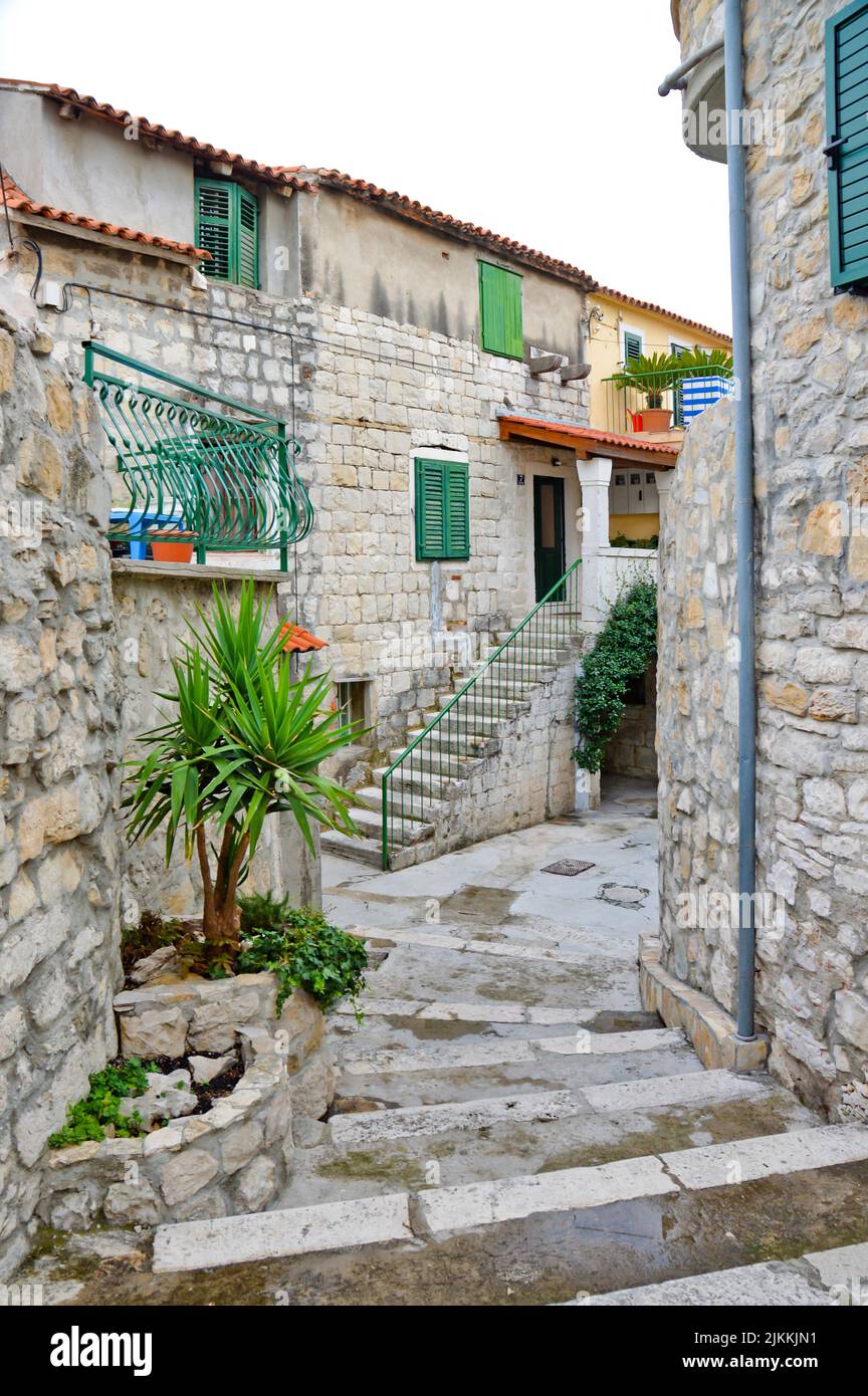 Un colpo verticale di case in pietra con carino esterno in uno stretto vicolo a Spalato, Croazia Foto Stock