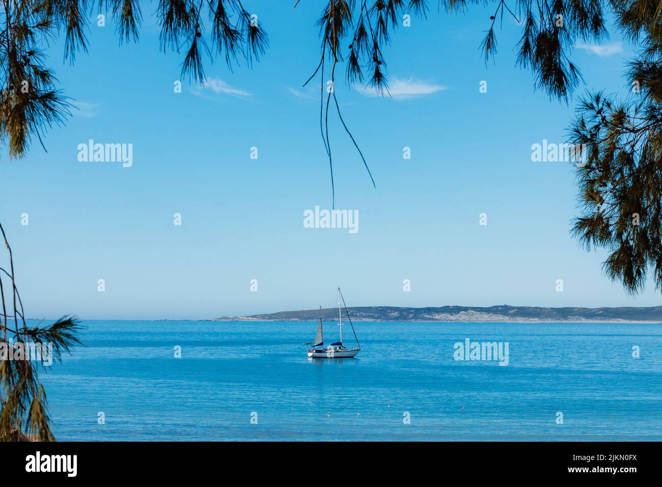 Una vista panoramica di uno yacht che naviga su un mare calmo durante l'estate Foto Stock