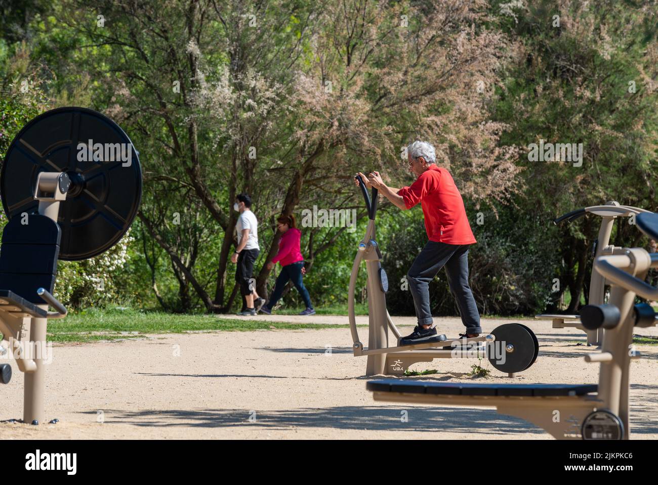 Un vecchio che fa le attività fisiche nel giardino alla luce del giorno Foto Stock