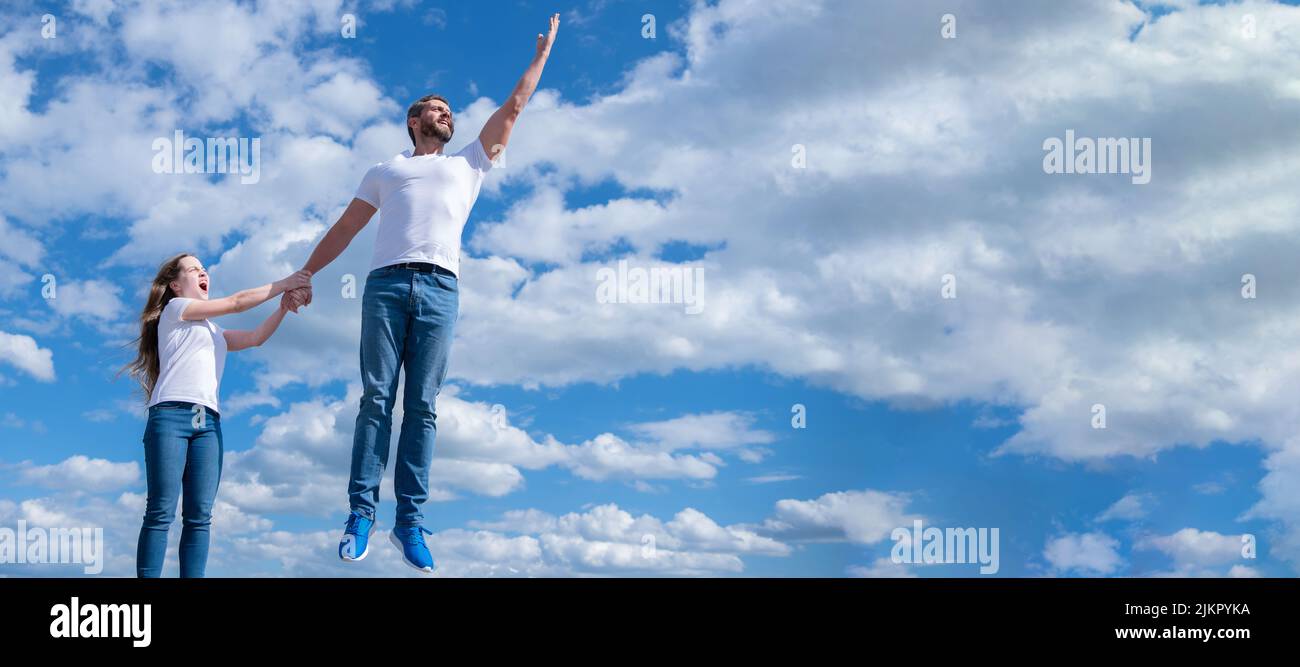 Padre e figlia che saltano nel cielo, banner con spazio copia. Foto Stock