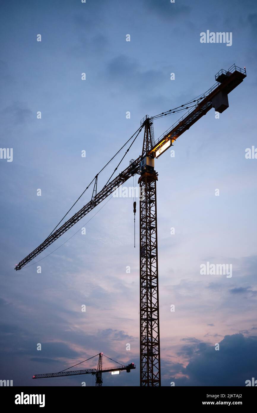 Uno scatto verticale della gru a torre al bellissimo tramonto Foto Stock