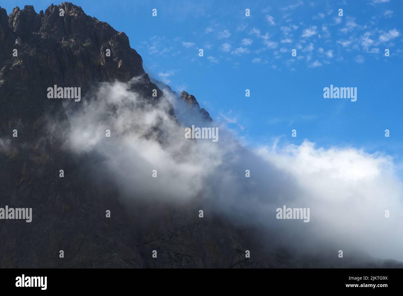 Una vista panoramica della catena montuosa dei Pirenei ricoperta di nuvole in una giornata di sole Foto Stock