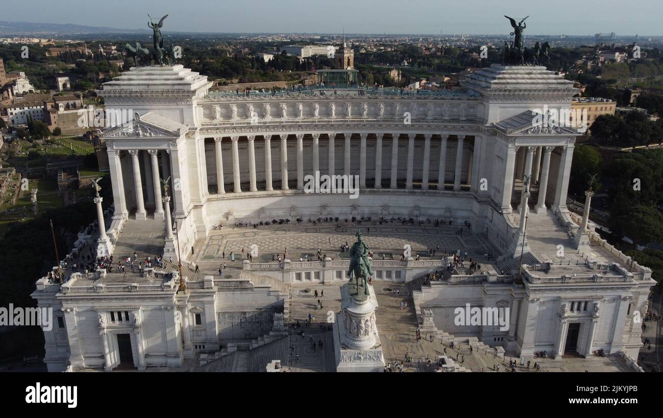 Una veduta d'area del monumento nazionale a Vittorio Emanuele II e la gente cammina in una giornata di sole a Roma Foto Stock