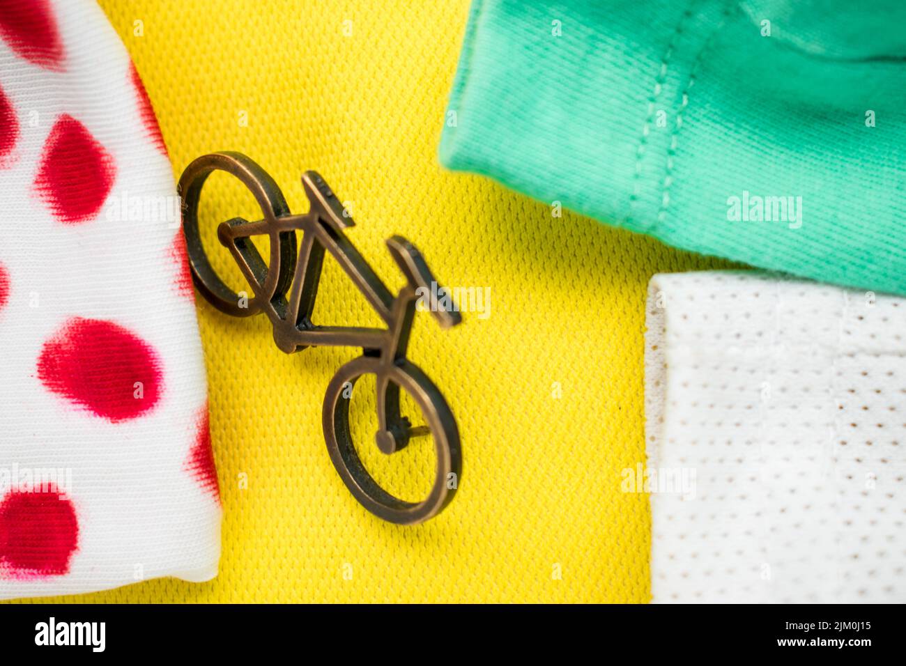 Un primo piano di un piccolo spilla su una t-shirt gialla, verde e bianca per un tour de France Foto Stock