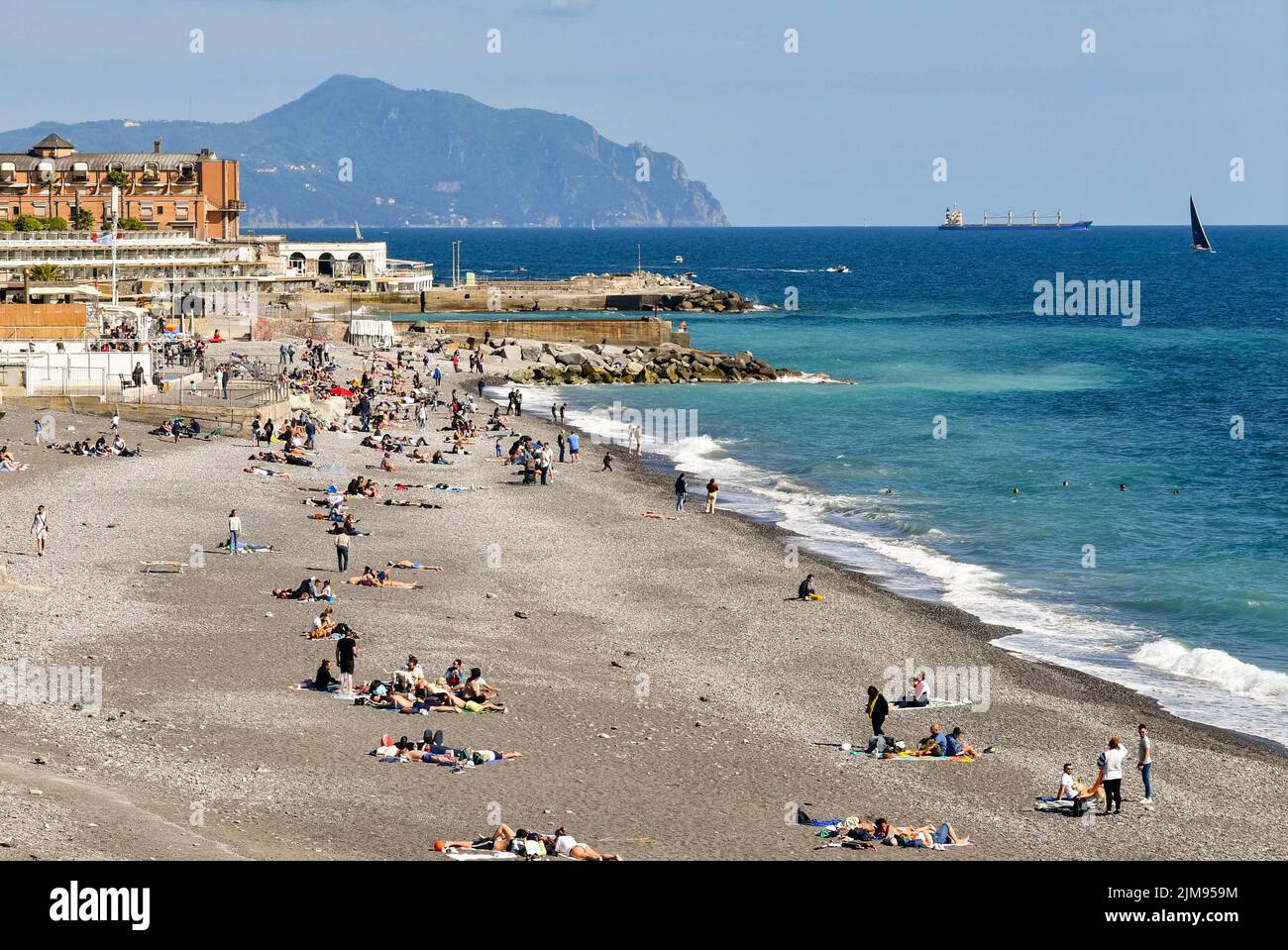 Vista panoramica della spiaggia di Albaro con i turisti il lunedì di Pasqua e il promontorio di Portofino all'orizzonte del mare, Genova, Liguria, Italia Foto Stock