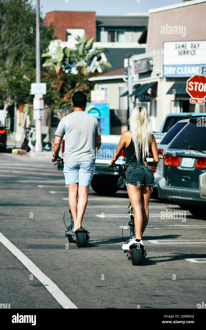 Un paio di scooter elettrici a cavallo su Rose Ave Foto Stock