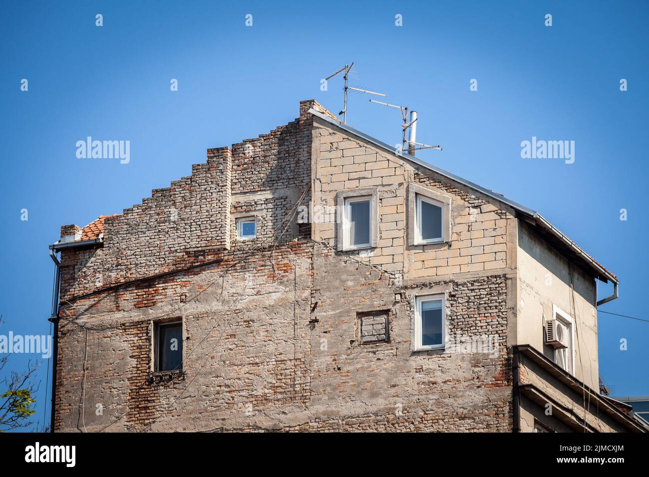 Immagine di un edificio a Belgrado, in Serbia, con un pavimento illegale e aggiunta di storia, infrangendo il codice di costruzione. Foto Stock