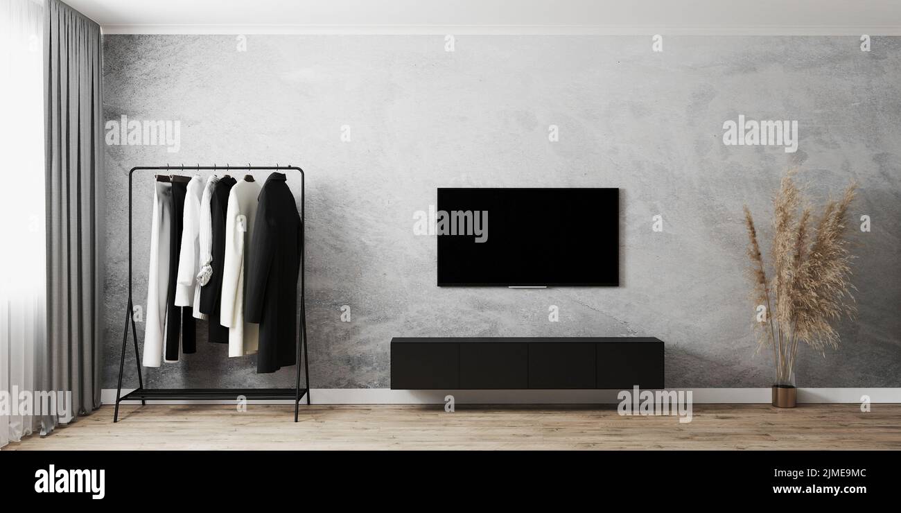 Camera moderna interna con appendiabiti, TV con armadi neri, parete grigia in cemento e pavimento in legno, finestra con tende grigie, Foto Stock