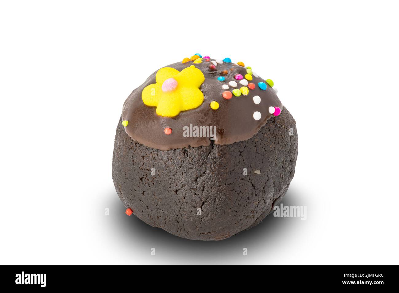 Vista laterale del bordo di una pallina di cioccolato con spolverini di arcobaleno e fiore di zucchero giallo. Foto Stock