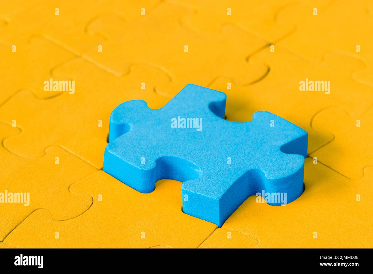 Il pezzo di puzzle blu si distingue dalla folla Foto Stock