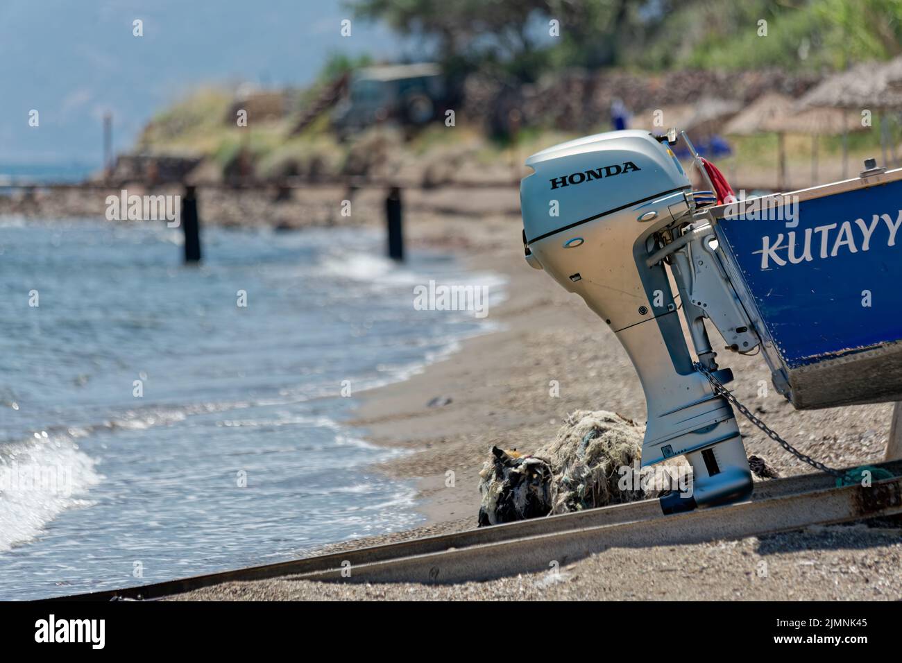 Honda fuoribordo barca a motore sul retro di una piccola barca sbarcato sulla spiaggia. Foto Stock