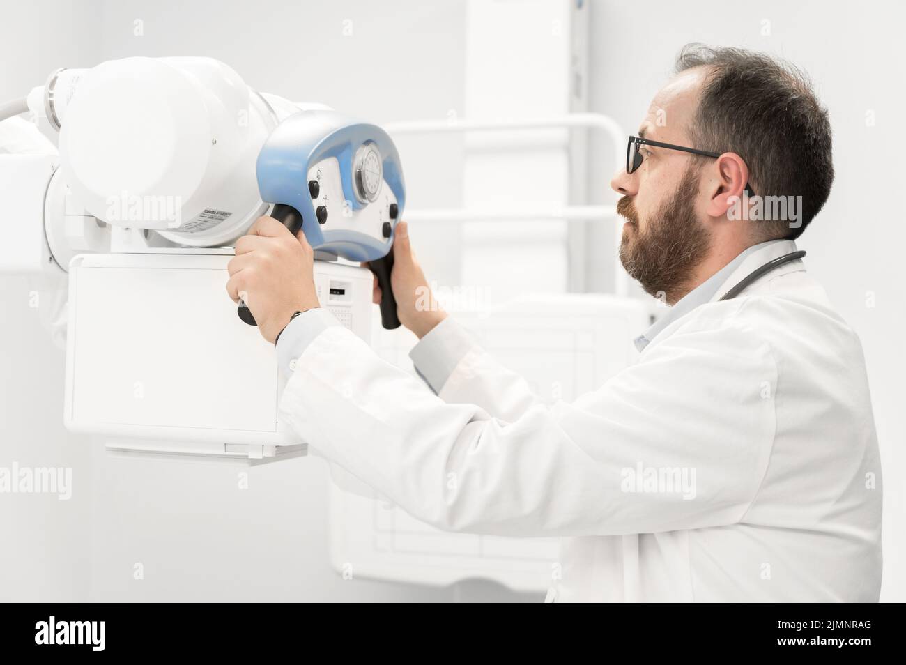 Medico che utilizza la macchina radiologica nel reparto di radiologia Foto Stock