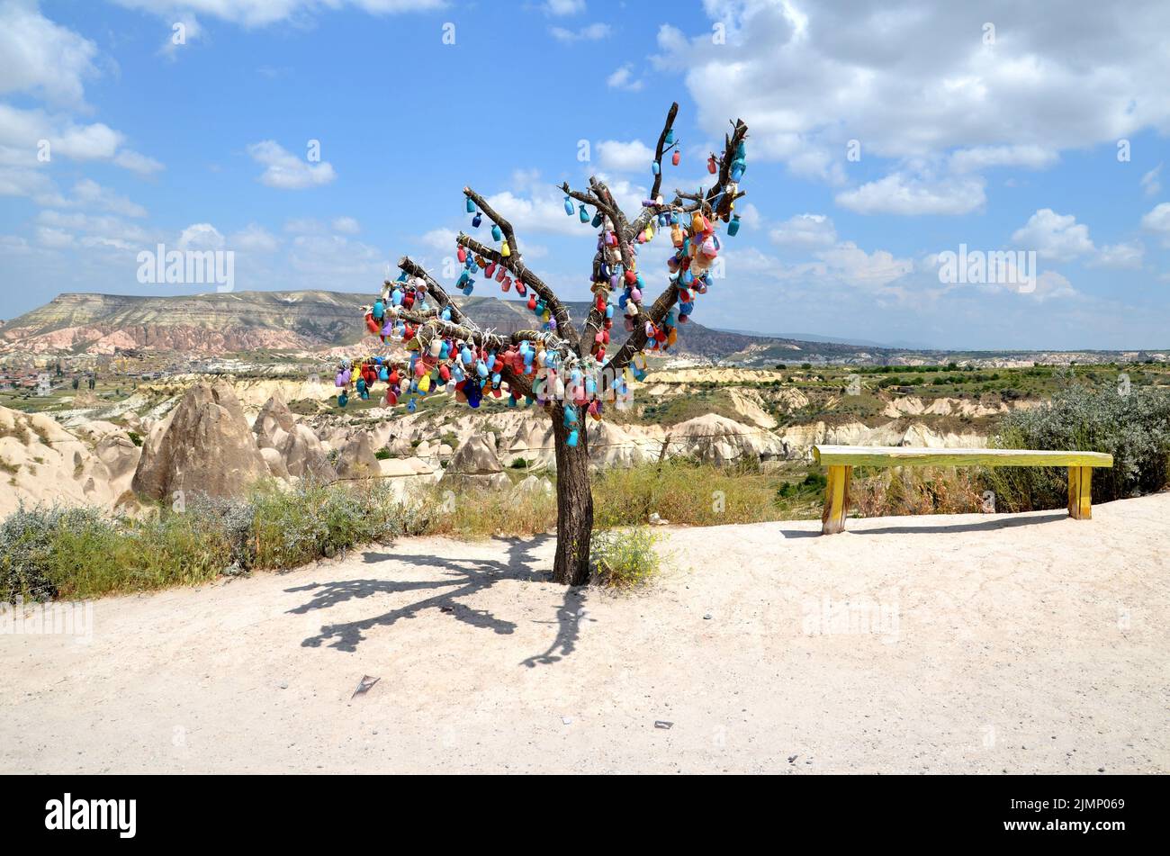 albero colorato decorato e una panca con le colline cappadocia sullo sfondo Foto Stock