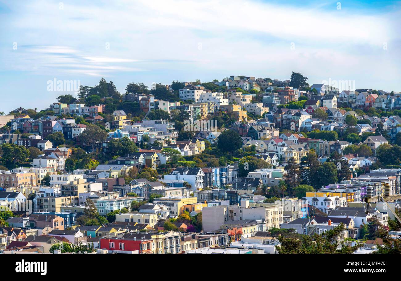 File di case e appartamenti su un terreno inclinato a San Francisco, California. Vista ad alto angolo di una comunità suburbana con fondo cielo bianco Foto Stock