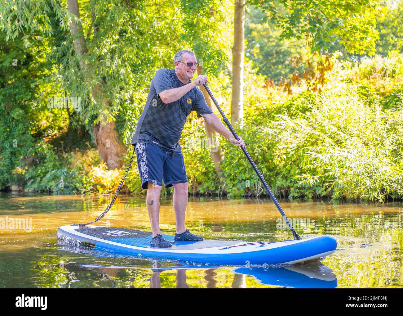 Kidderminster, Regno Unito. 7th Agosto 2022. Tempo britannico: Con il caldo tempo di sole, la gente del posto farà qualsiasi cosa per salire sull'acqua. Il canale locale Worcestershire è perfetto per Phil e per la sua tavola da paddle stand-up: Questo è solo il secondo tempo in acqua per lui... e lui ne sta godendo ogni momento! Credit: Lee Hudson/Aalmy Live News Foto Stock