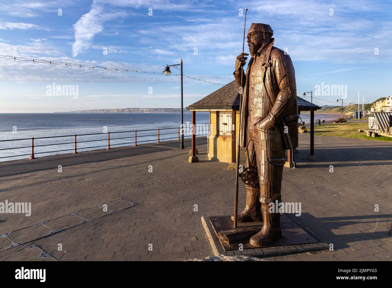 Una High Tide in Short Wellies, una scultura di Ray Lonsdale di un pescatore che si erge alto e orgoglioso sul lungomare di Filey, North Yorkshire. Foto Stock