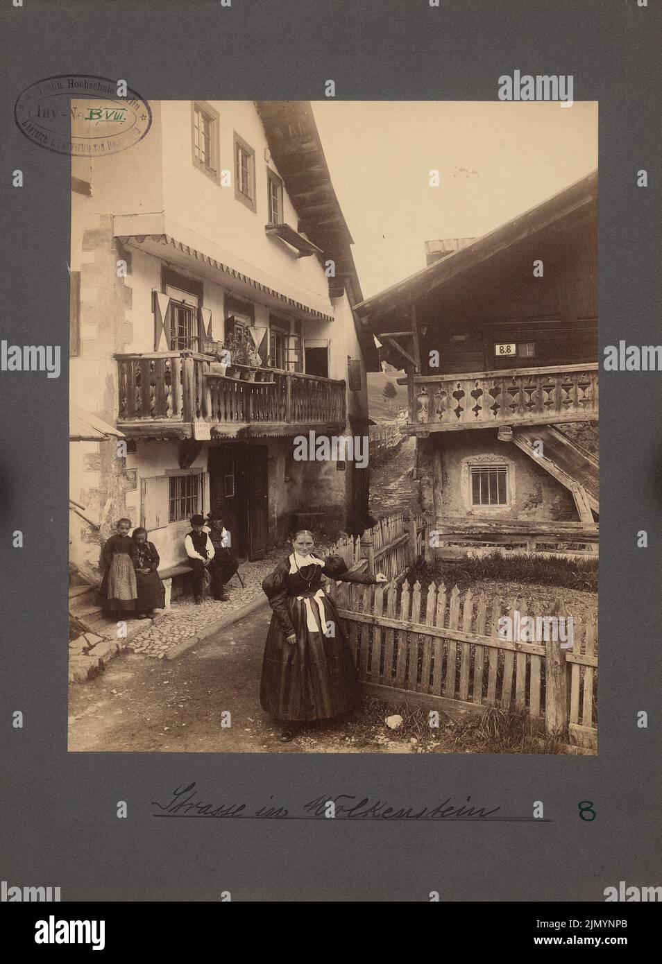 Fotografo sconosciuto, scena stradale (case bavaresi superiore e architettura in legno), Wolkenstein (senza dat.): Vista in sezione Case con gallerie in legno, in primo piano sulla recinzione donna in un abito tradizionale. Foto, 31,7 x 23,3 cm (inclusi i bordi di scansione) Foto Stock