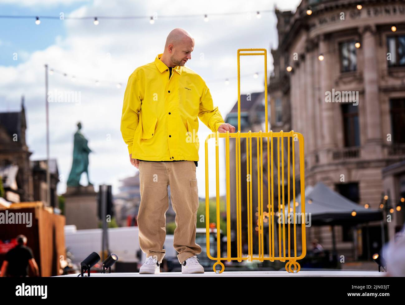 L'artista Kostya Benkovich, fuggito dalla Russia a causa della sua posizione anti-guerra, presenta la sua scultura The Suitcase durante una chiamata fotografica ai Giardini dell'Assemblea, Edimburgo. Data foto: Lunedì 8 agosto 2022. Foto Stock