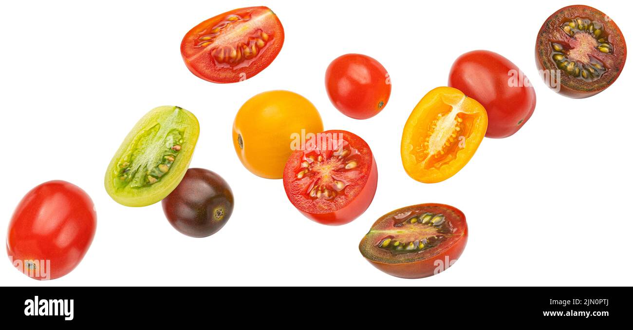 Pomodori ciliegini colorati cadenti isolati su sfondo bianco Foto Stock