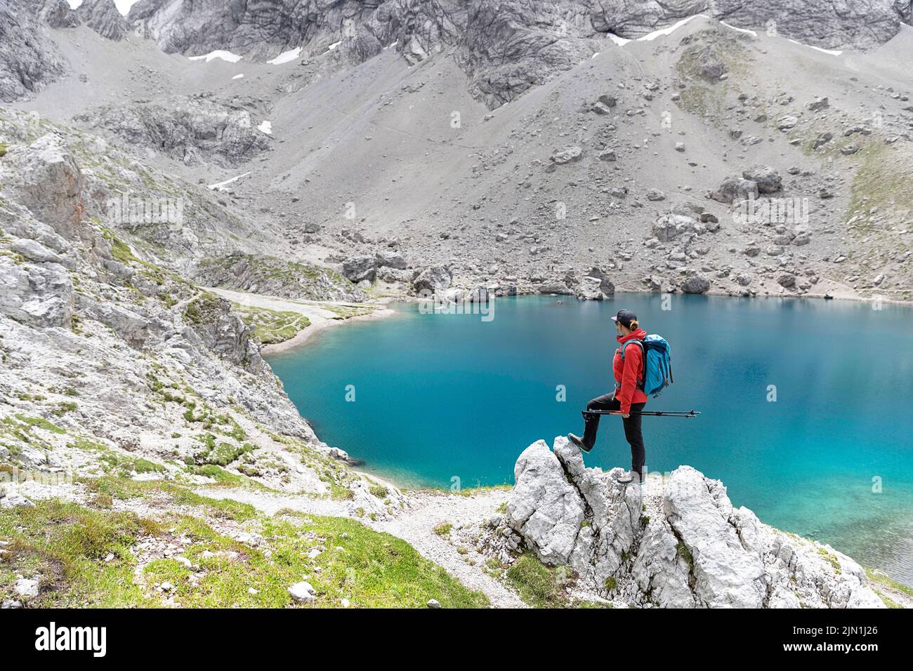 Donna escursionista che guarda il bellissimo lago alpino Laserzsee, sopra la città di Lienz, nelle Dolomiti di Lienz, Tirolo Orientale, Austria, Europa Foto Stock