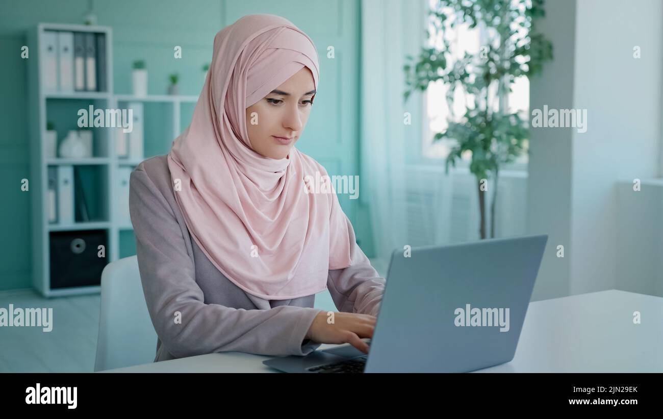 Triste scioccato arabo indiano musulmano islamico scioccato imprenditore errore di lavoratore nel documento online errore computer chiudere bocca con mano dal fallimento Foto Stock