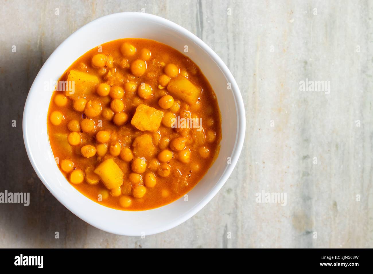 Focalizzazione selettiva del delizioso cibo di strada bengalese 'Ghugni' fatto di ceci. Con uno sfondo di marmo. Foto Stock