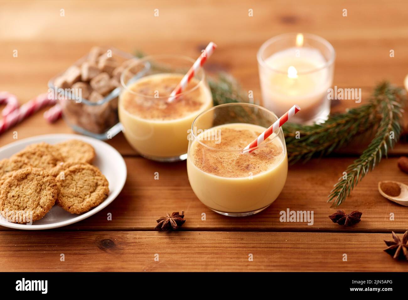 bicchieri di eggnog, biscotti di farina d'avena e ramo di abete Foto Stock