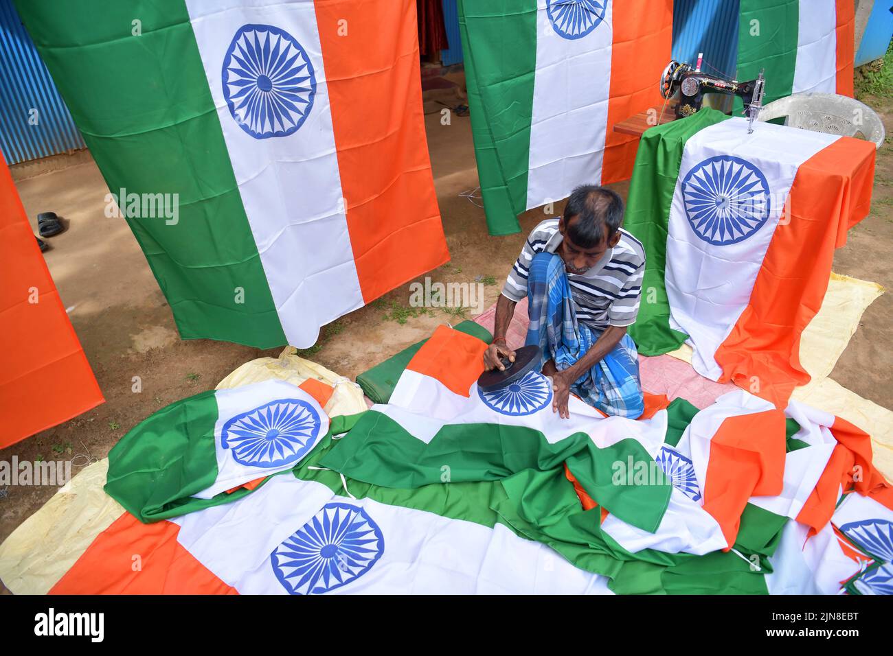 I lavoratori preparano le bandiere nazionali indiane in un workshop in vista delle celebrazioni per la Giornata dell’Indipendenza dell’India nella periferia di Agartala. Tripura, India. Foto Stock