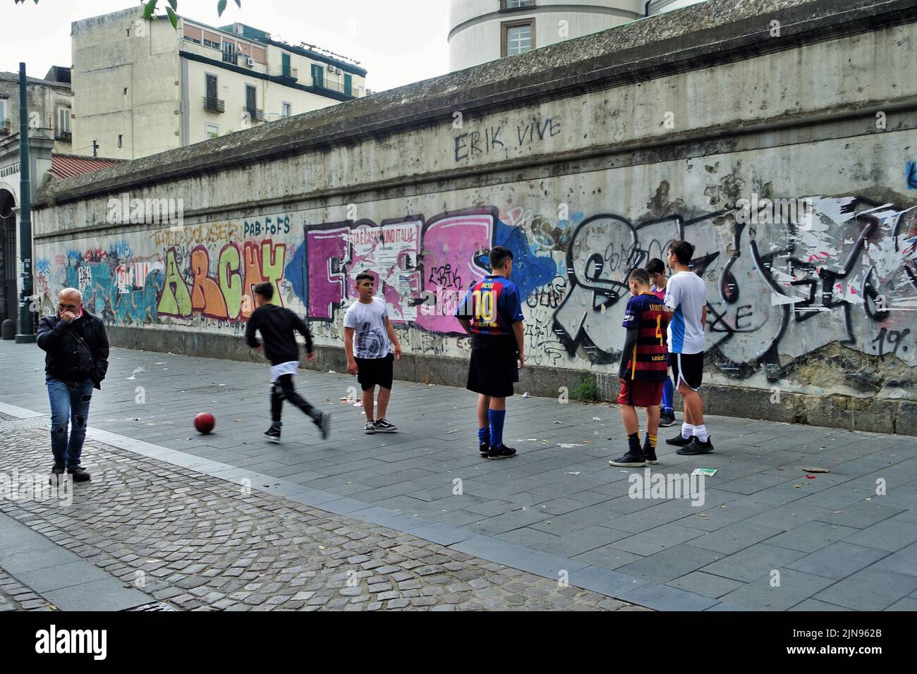 Graffiti murali di Wall art, bambini che giocano a calcio in strada, Napoli, Campania, Italia, Europa Foto Stock