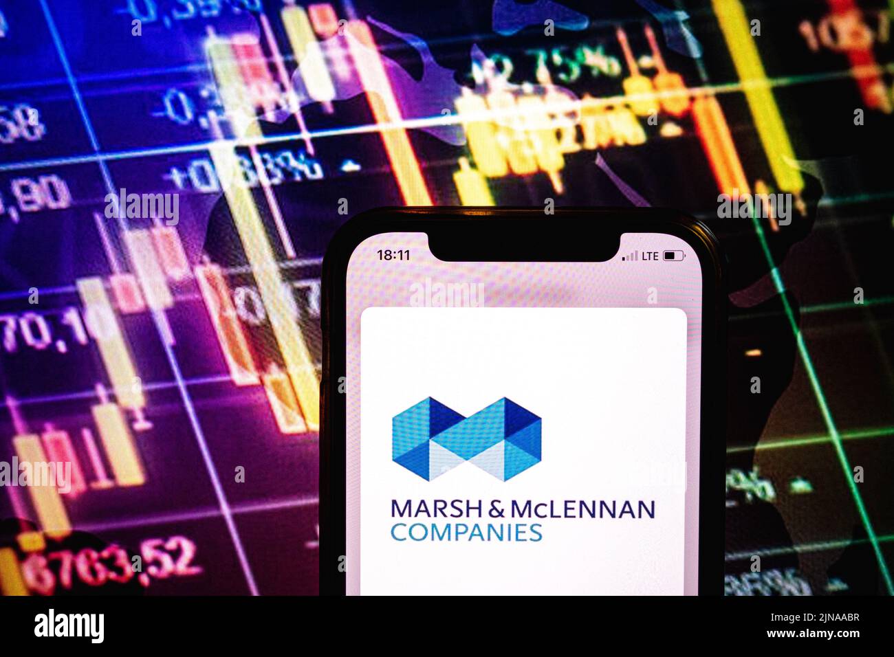 KONSKIE, POLONIA - 09 agosto 2022: Smartphone che mostra il logo delle società Marsh e McLennan sullo sfondo del diagramma di borsa Foto Stock