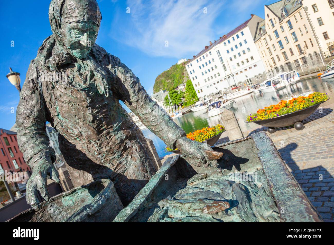 Porto di Alesund con statua dei pescatori all'alba, Norvegia, Scandinavia Foto Stock
