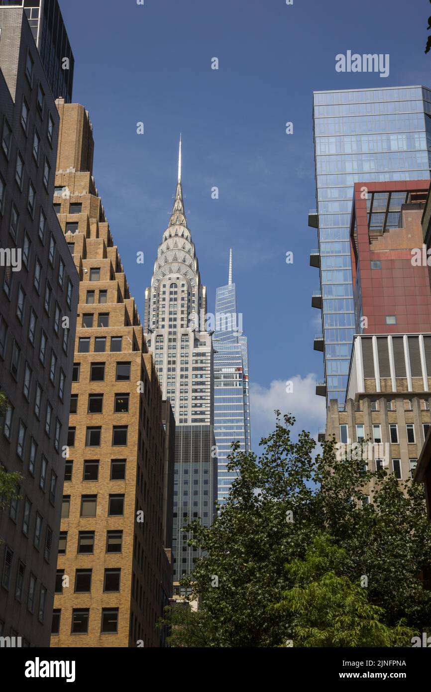 Guardando verso ovest attraverso gli alberi dall'estremità orientale della East 43rd Street, l'iconica Chrysler Tower con la nuova 1 Vanderbilt Tower è chiaramente visibile nel centro di Manhattan. Foto Stock